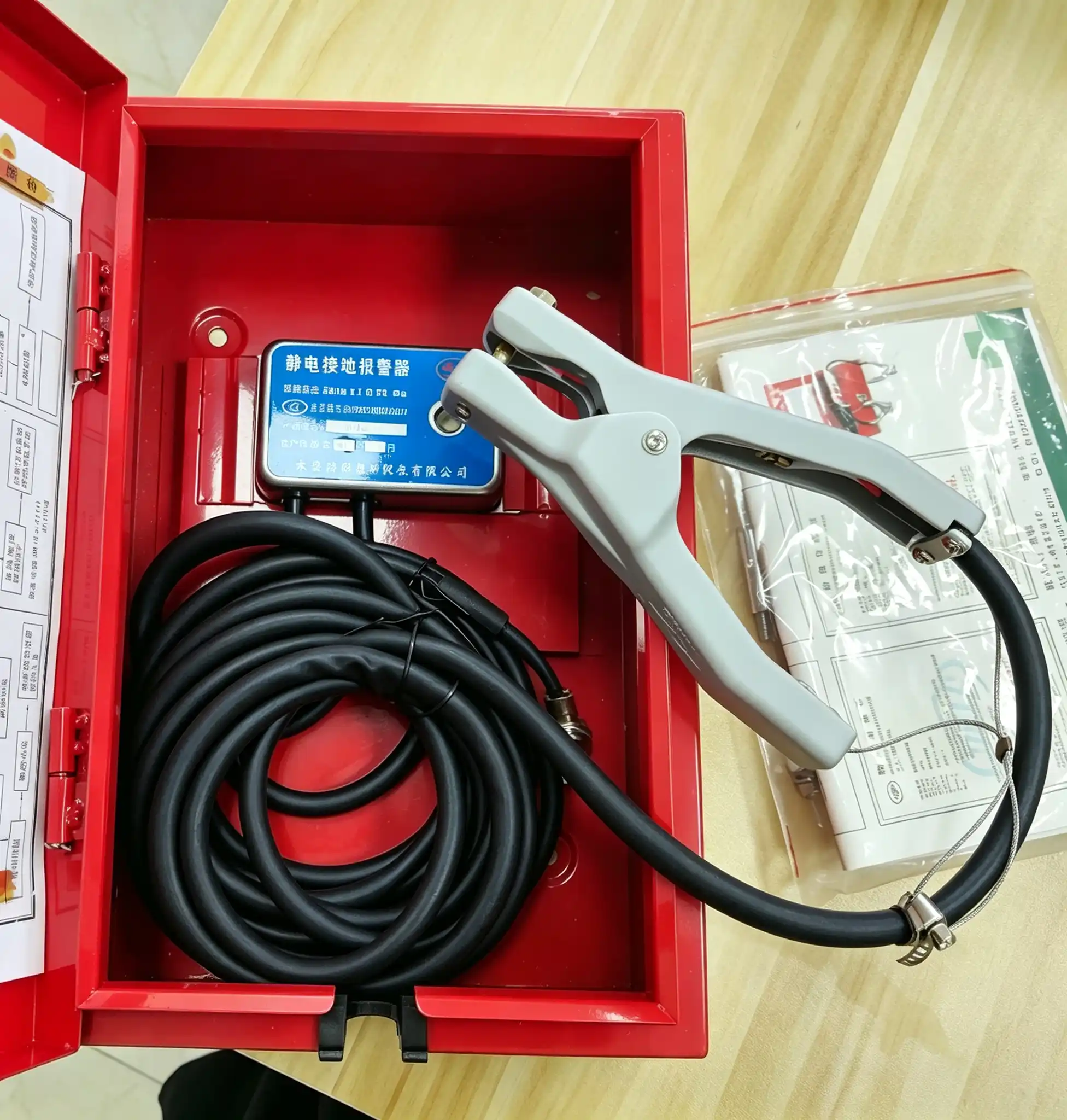 static grounding alarm inside box accessories static grounding alarm open box view, earthing clamp, spiral cable, certification documents